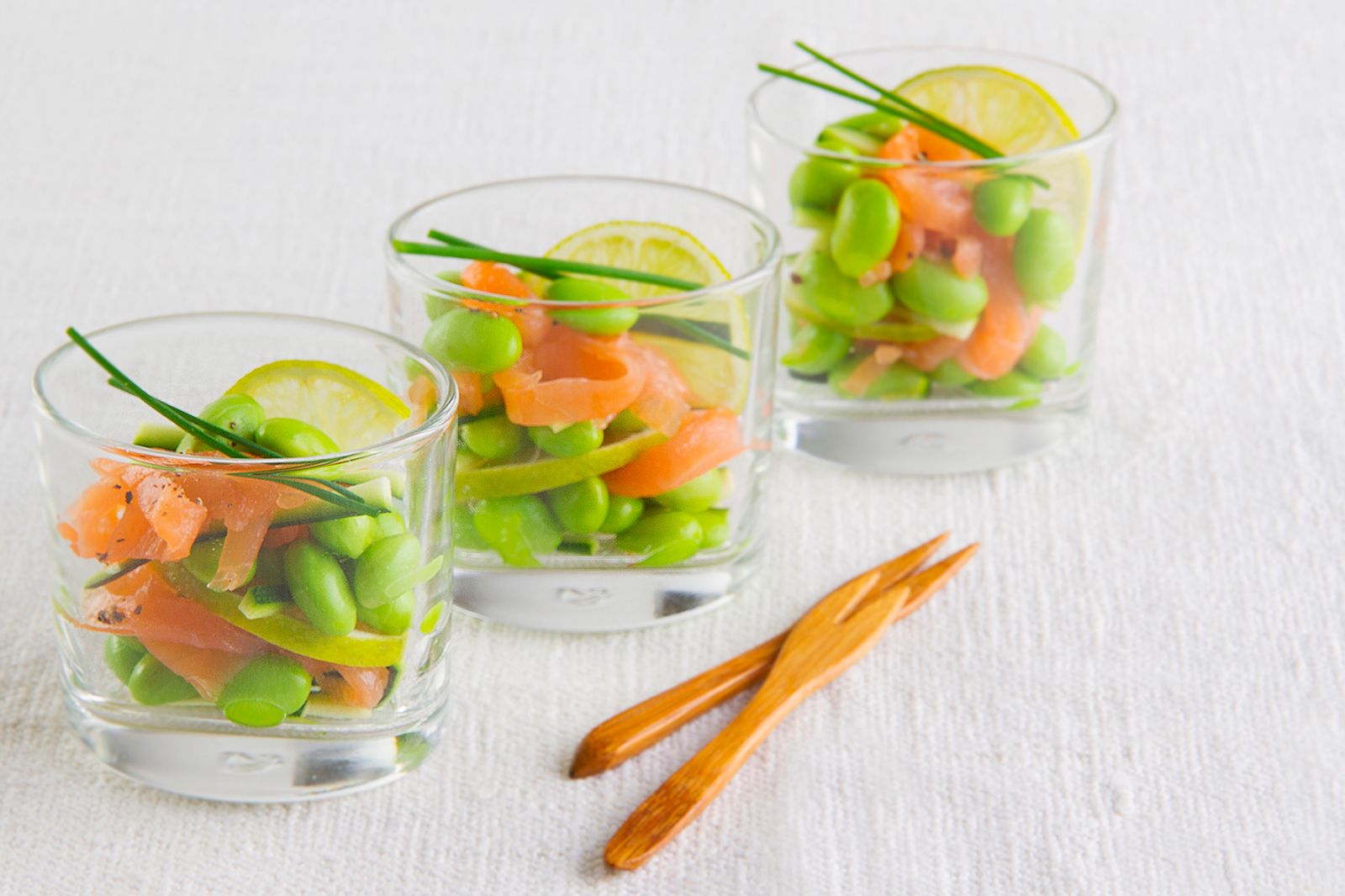 Small glasses with edamame soybeans, salmon and courgettes