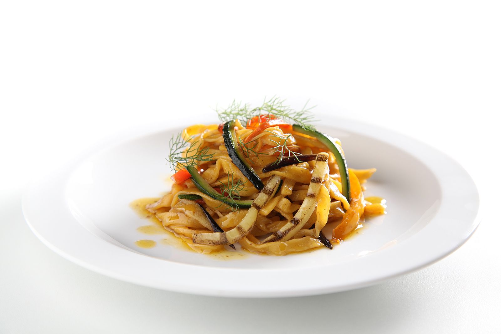 Egg tagliolini with cherry tomatoes of Vesuvius and grilled vegetables in stick